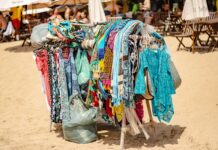 colorful beach clothing display on sandy shore