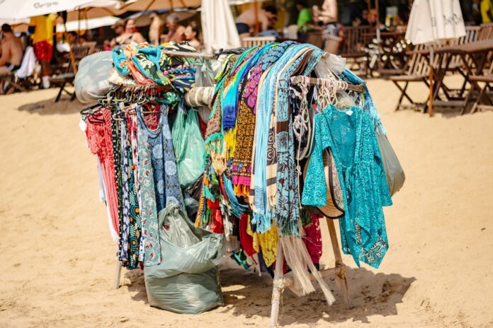 colorful beach clothing display on sandy shore