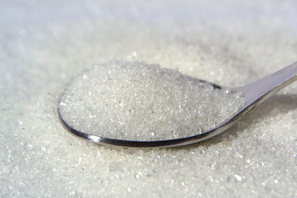 close up of white sugar crystals on a spoon