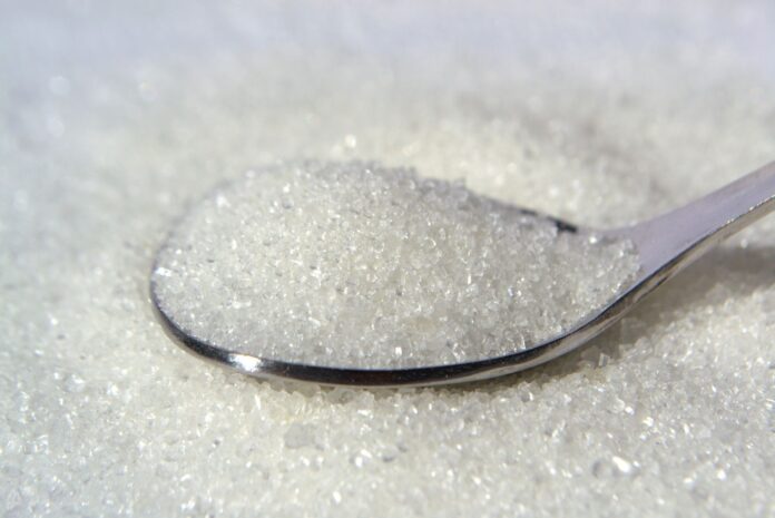 close up of white sugar crystals on a spoon