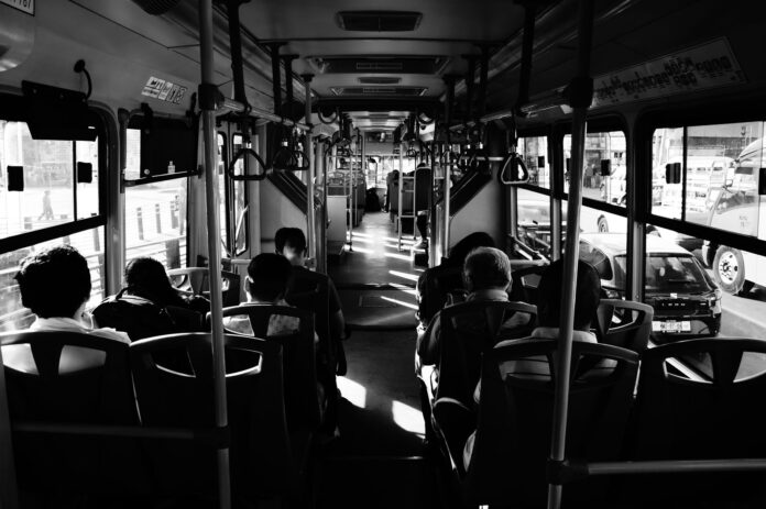 pexels-photo-3723002 grayscale photo of people sitting inside a bus