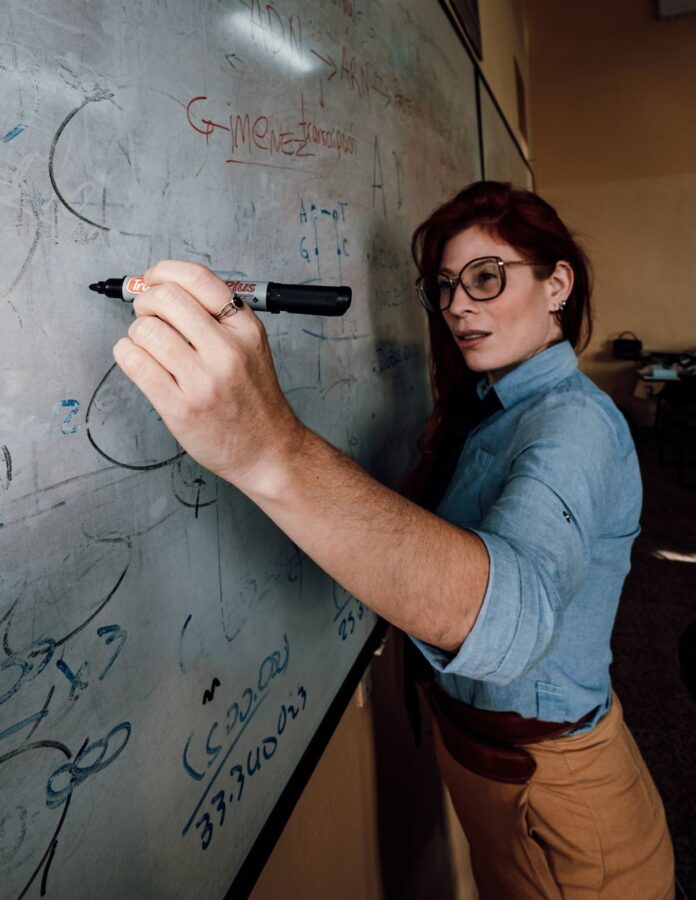 female teacher writing on whiteboard in buenos aires